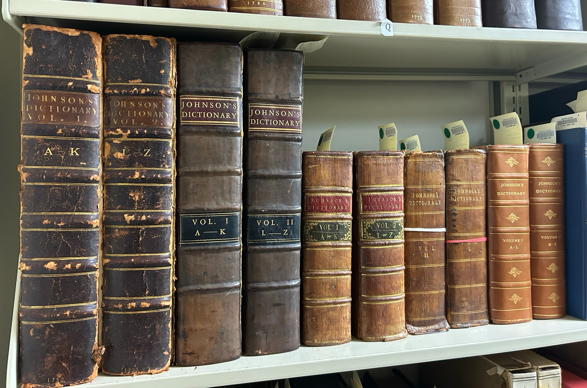 Editions of Johnson's Dictionary on a shelf