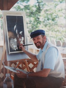 Portrait of Calvin Miller as he paints a still life